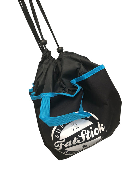FatStick changing mat plus wetsuit bag, shown open with a drawstring closure and blue trim.