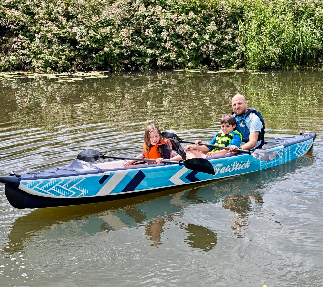 Father and child paddling the inflatable 1-2 person drop stitch kayak package canoe ikayak in a river.
