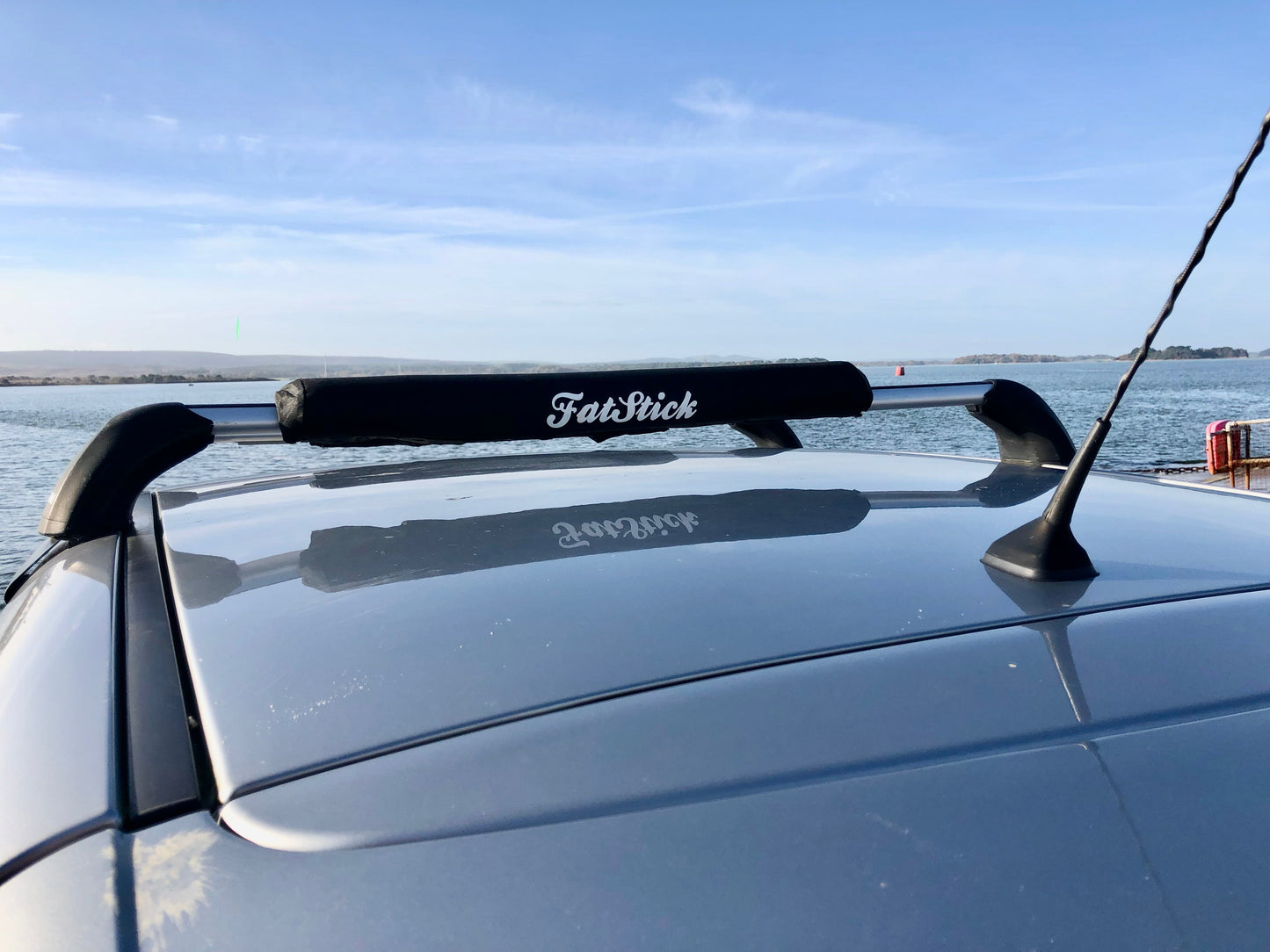FatStick Long Aero Roof Rack Bar Pad 71cm on a car roof rack overlooking the ocean