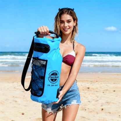 Woman on a beach holding a blue 20Ltr FatStick Dry Bag & Backpack, showcasing its size and portability.