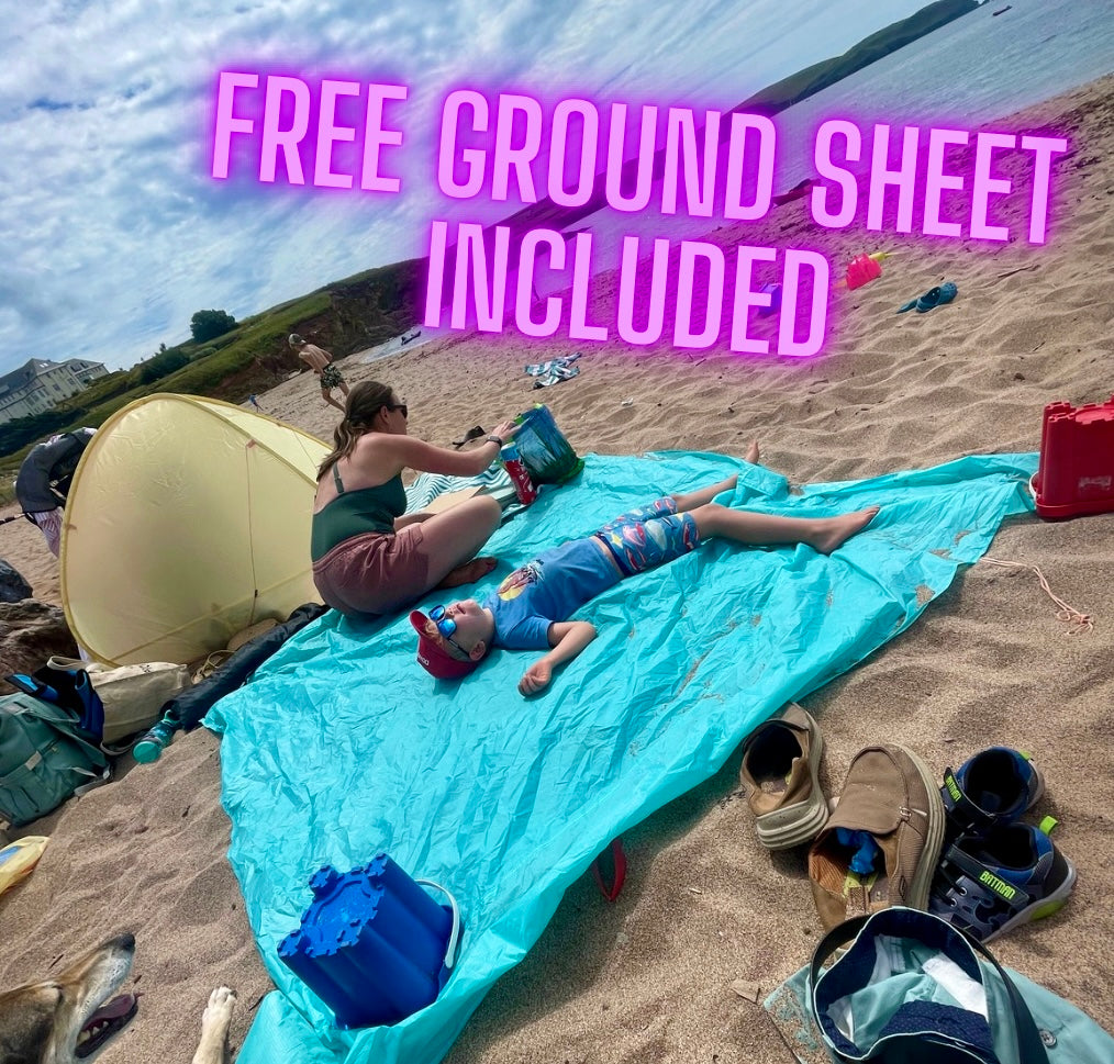 Blue ground sheet on a sandy beach with a woman and child, text 'FREE GROUND SHEET INCLUDED'.