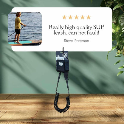 FatStick Boards 10ft black coiled SUP ankle leash with a customer review overlay