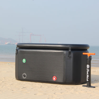 FatStick pro cold water therapy plunge pool and pump on a sandy beach, ocean in background.