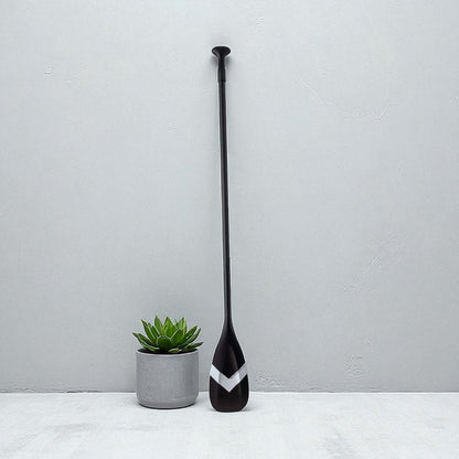 Full length shot of black FatStick full carbon 2 piece paddle board with blade and handle.