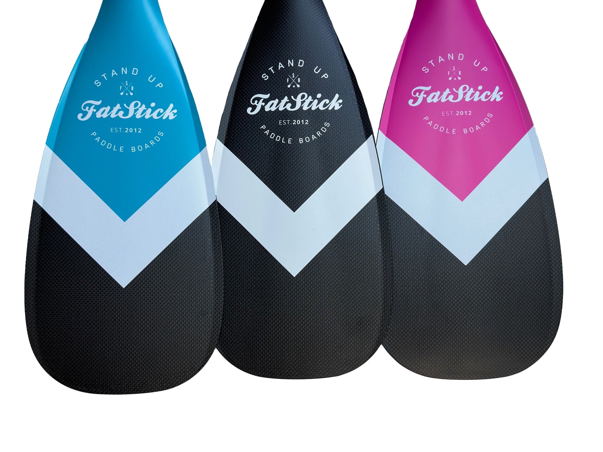 Three FatStick Boards full carbon paddle board paddles in blue, black, and pink with white chevron pattern.