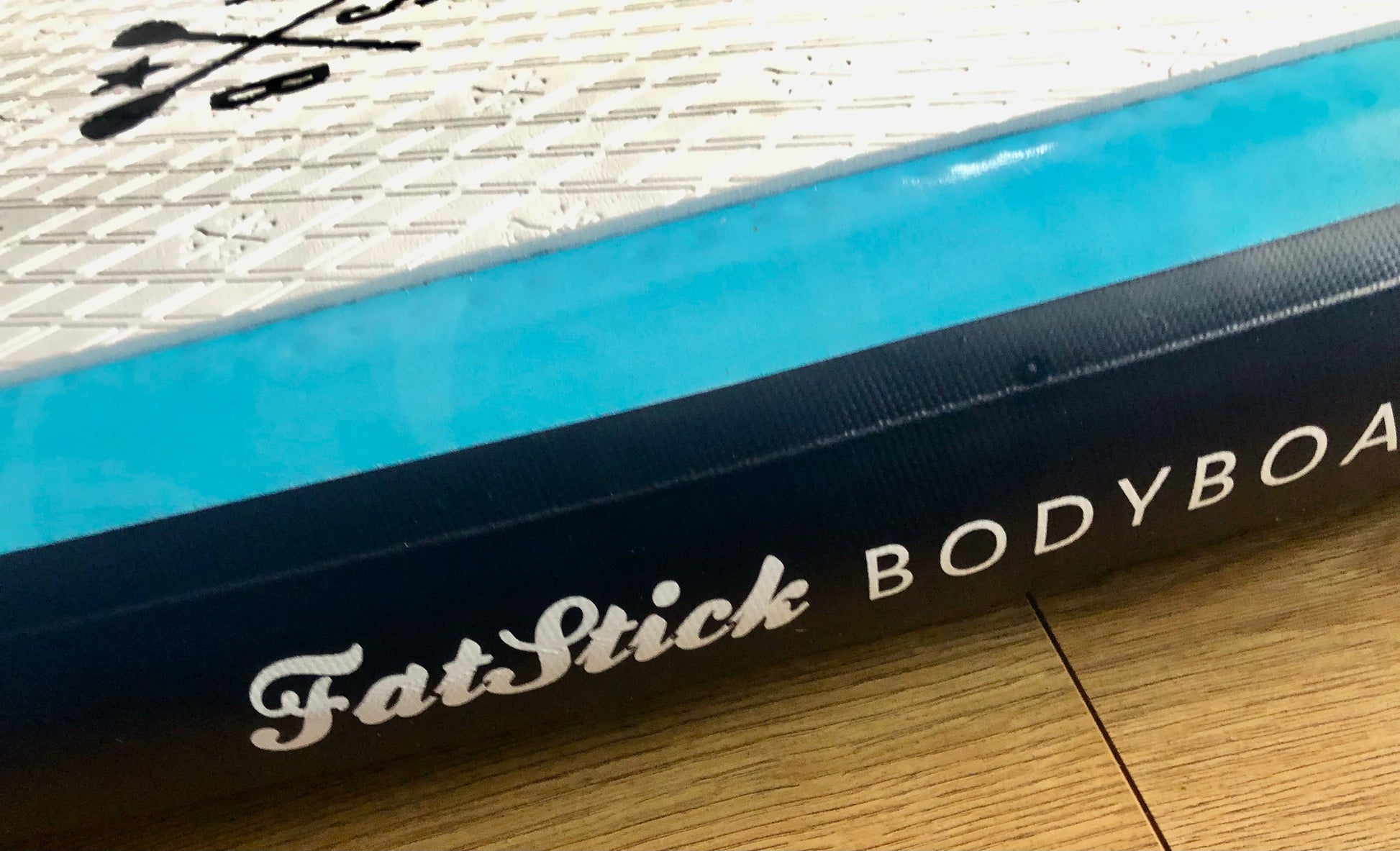 Close-up of the side of the Inflatable 43 Fatstick Body Board with the FatStick Bodyboard logo visible.
