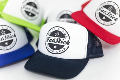 Close-up of several FatStick Team Trucker Hats in red, blue, and black with white fronts