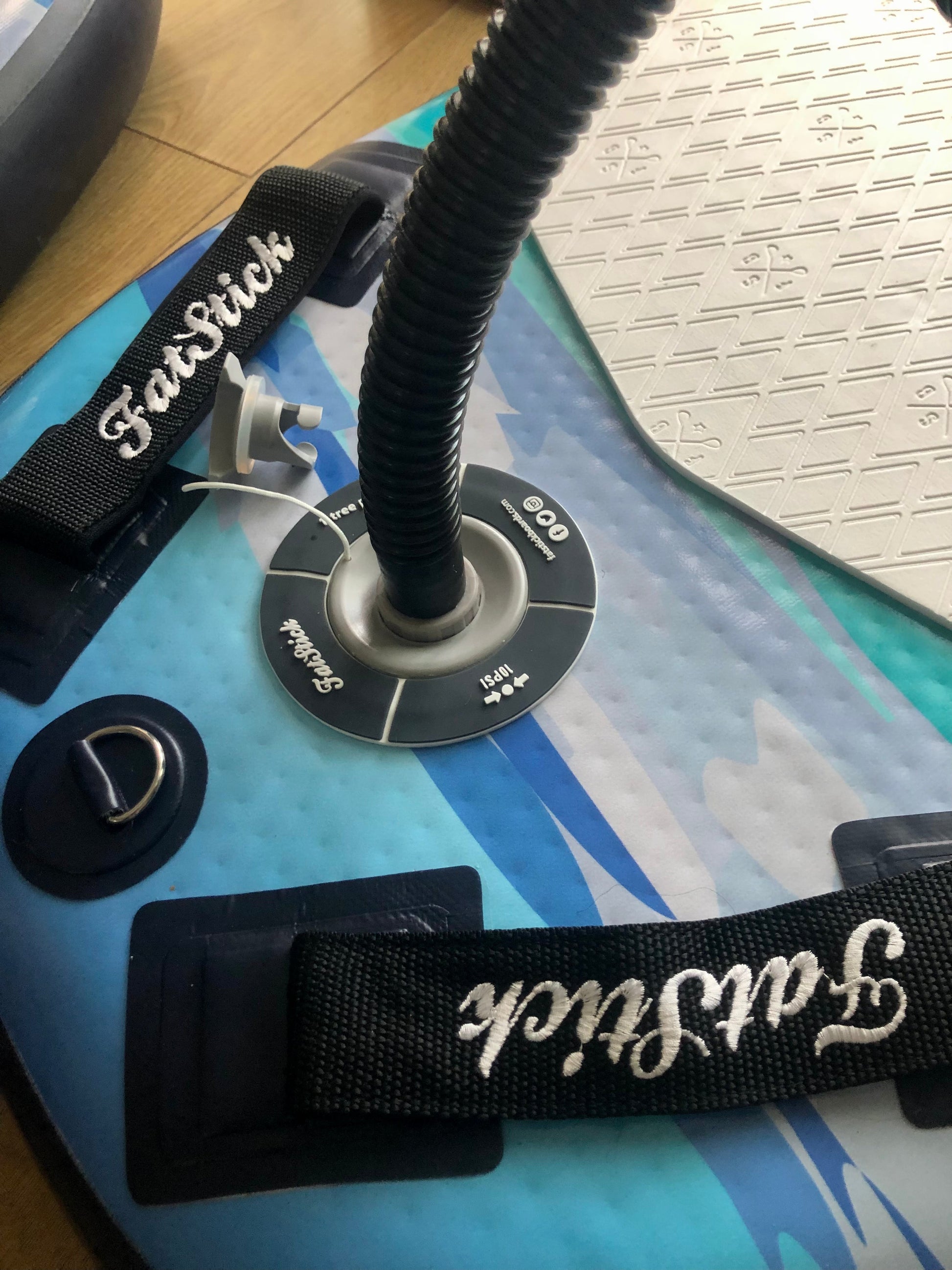 Close-up of the inflation valve and padded handles on the blue and white Inflatable 43 Fatstick Body Board.