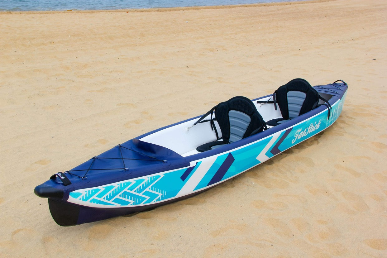 Angled view of the inflatable 1-2 person drop stitch kayak package canoe ikayak, empty on sand.
