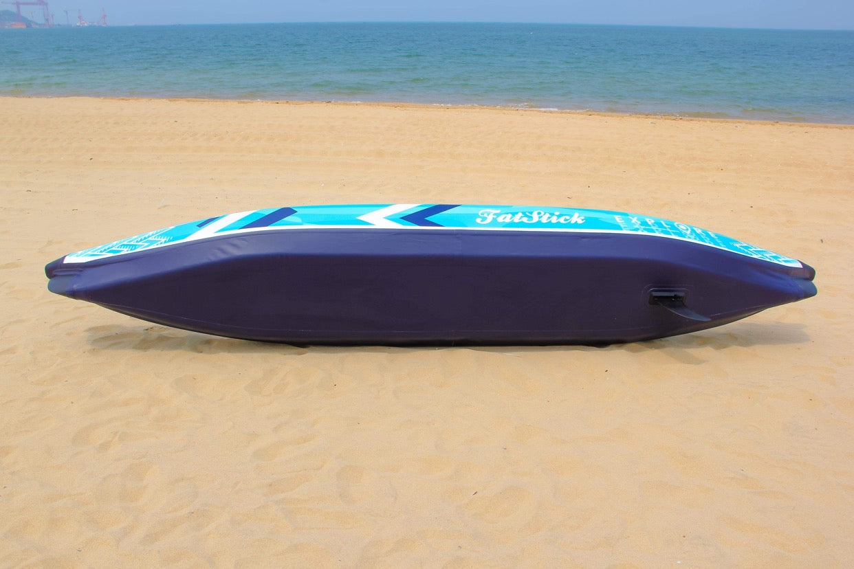Bottom view of the inflatable 1-2 person drop stitch kayak package canoe ikayak on a sandy beach.
