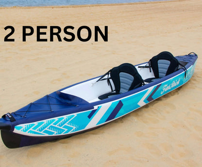 Inflatable 1-2 person drop stitch kayak package canoe ikayak on a sandy beach, set up for two people.