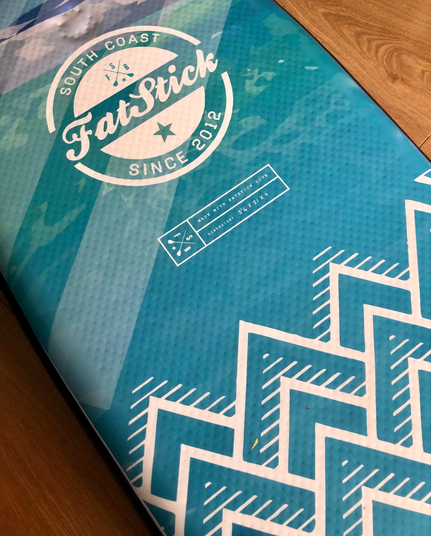 Close-up of the bottom of the blue and white Inflatable 43 Fatstick Body Board showing the design and branding.