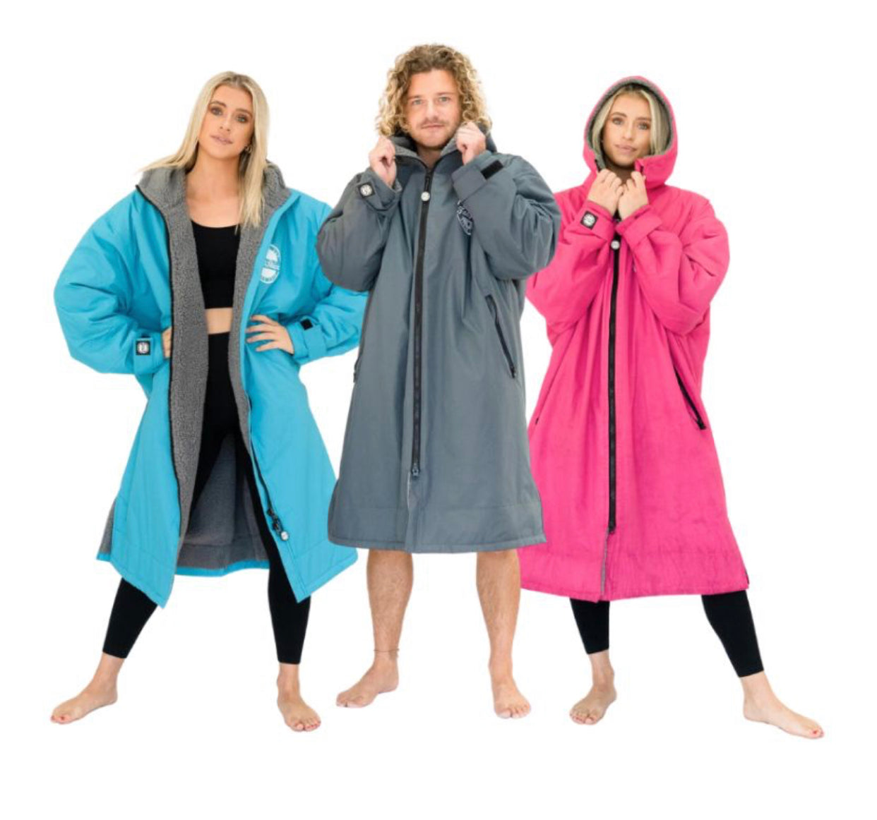 Three models wearing different colored FatWrap recycled fleece changing robes: blue, grey, and pink, standing barefoot.